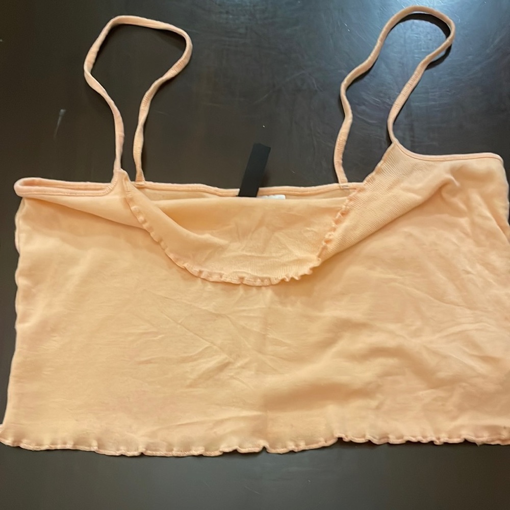 im selling this orangey coral tangtop.